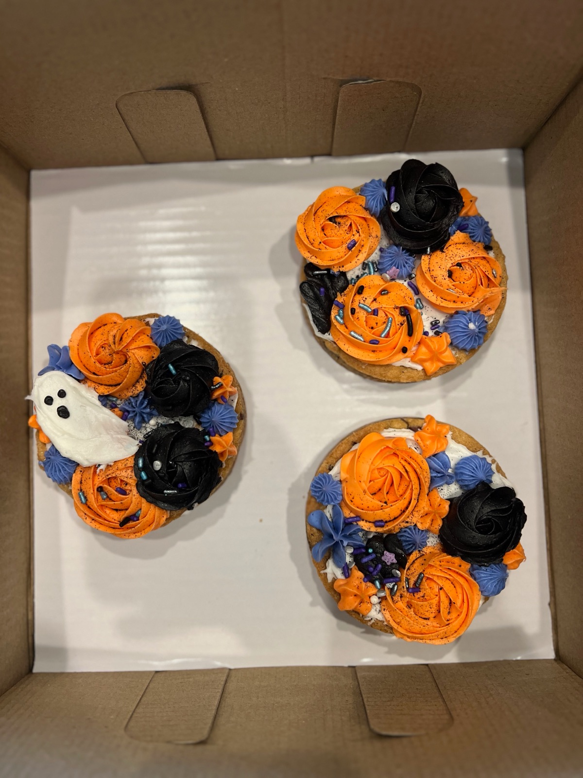 Halloween mini cookie cakes with orange and black rosettes